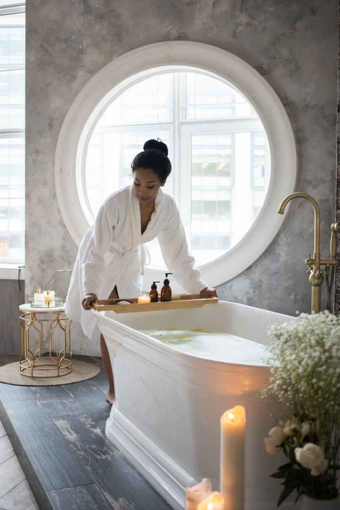 woman relaxing bath essential oil candle