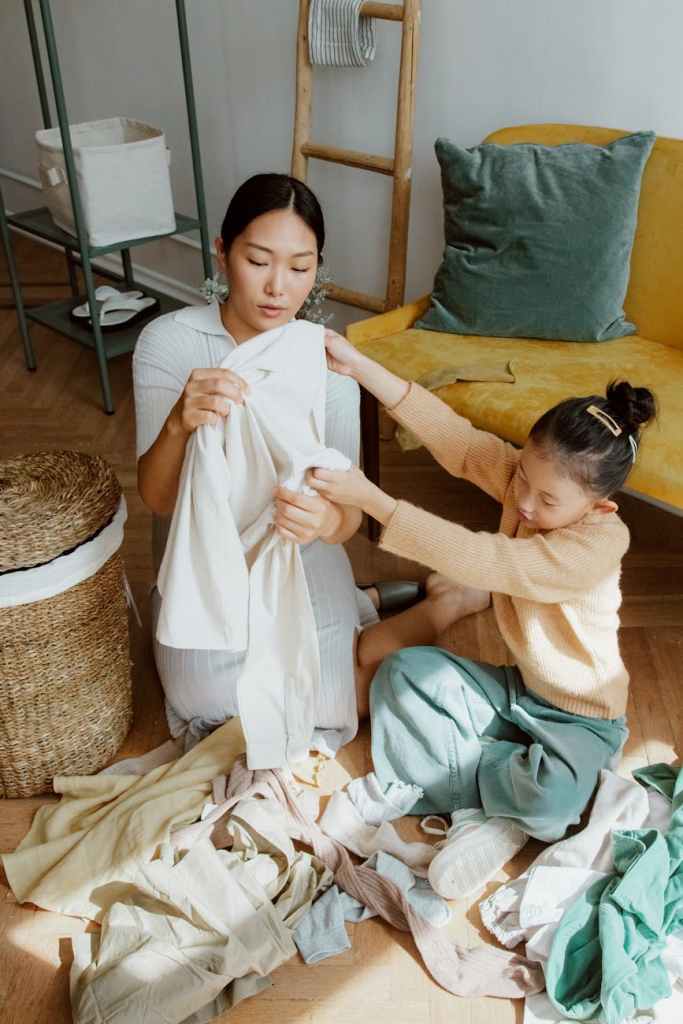 Mom and daughter organizing clothing together
