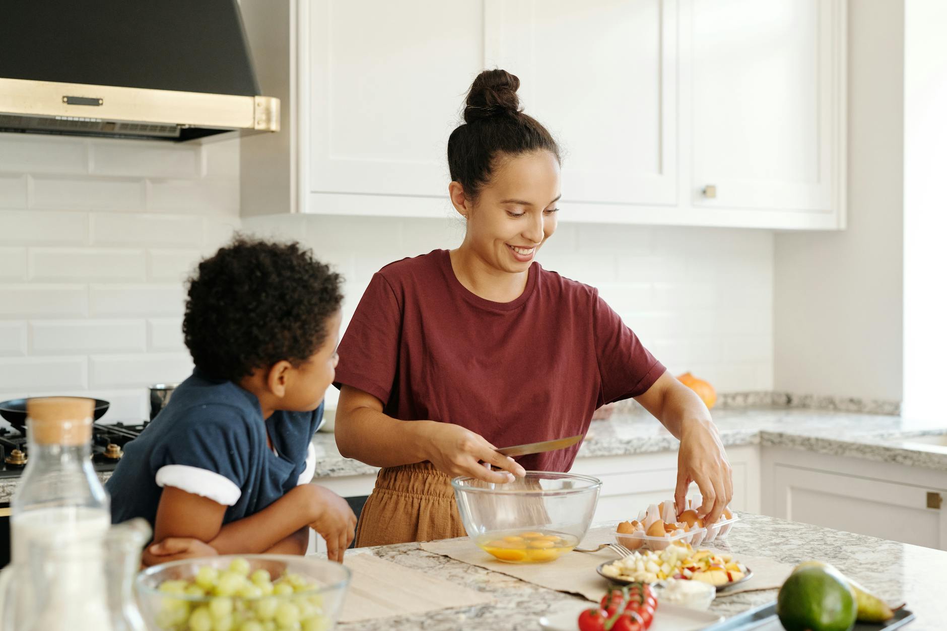 Son watching his Mom as she preps food for the week