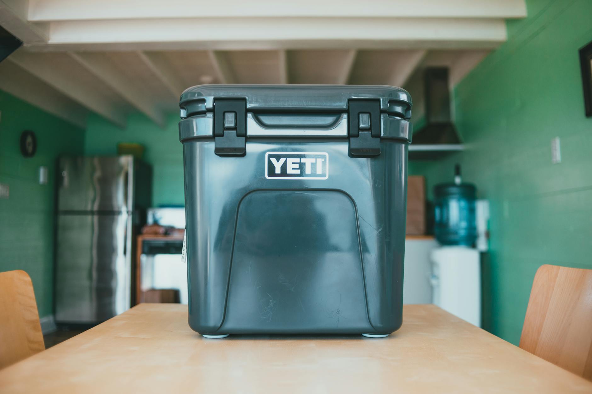 A green Yeti cooler on a kitchen table. 