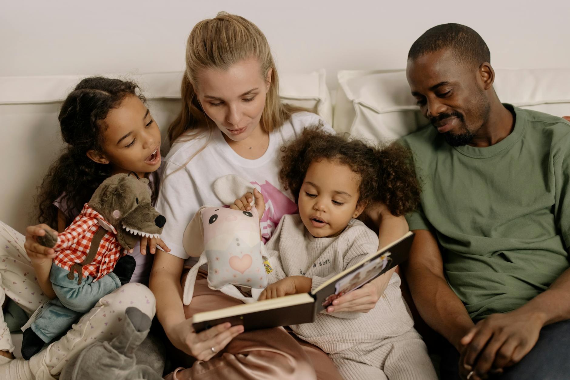 mom and dad reading two children a  bedtime story
