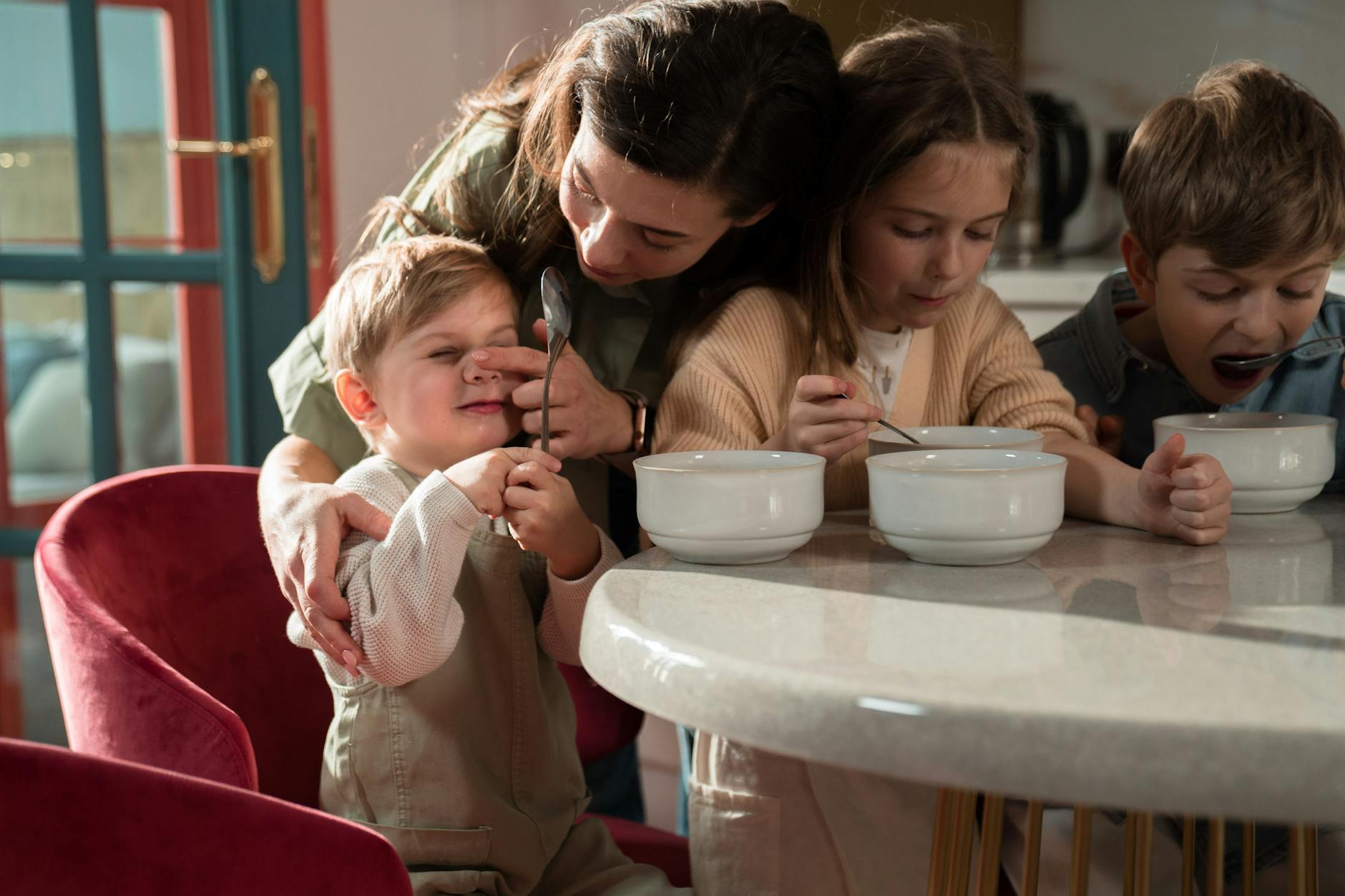 Mom eating breakfast with her children
