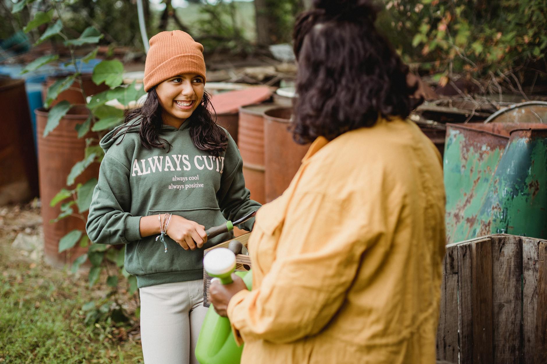 mom and daughter gardening and smiling