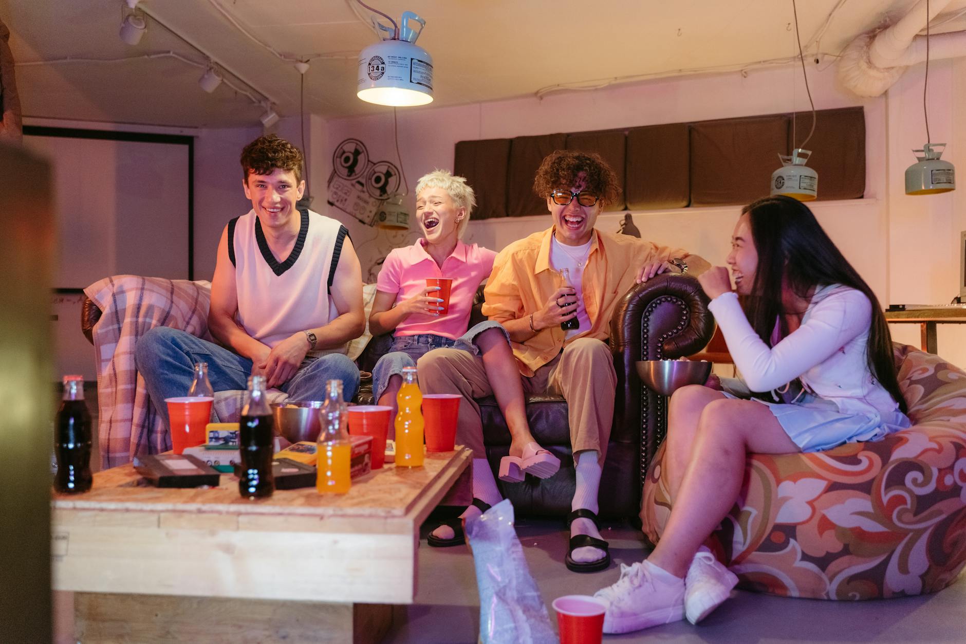 teens hanging out togeter having soda, laughing and talking
