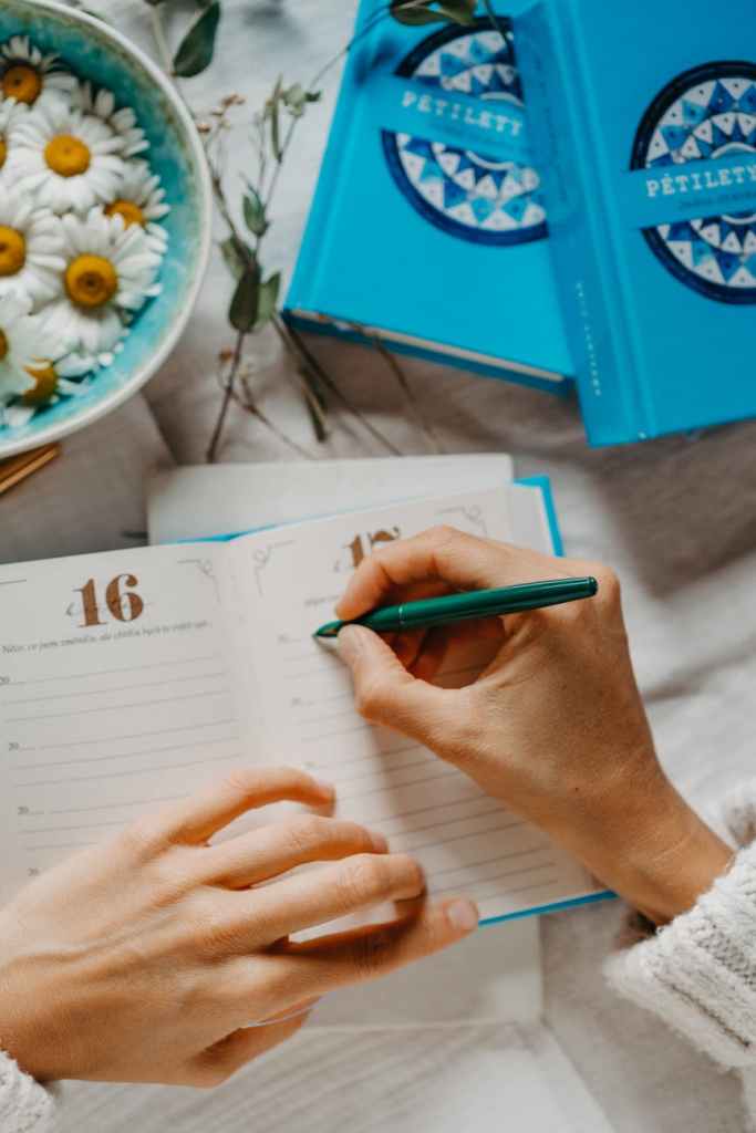 a woman writing in her planner