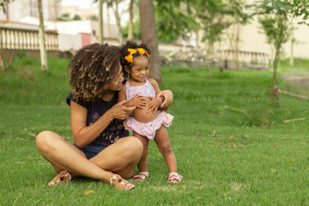 Mom and child relaxed together in backyard summer afternoon