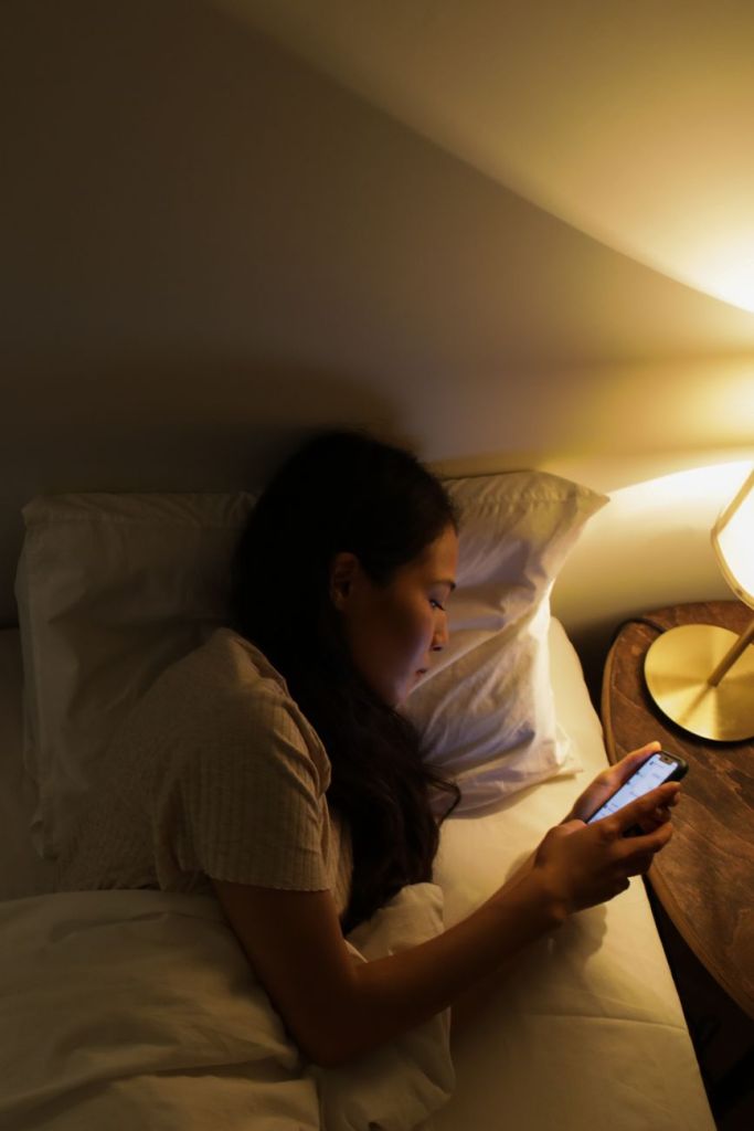 mom scrolling phone late at nigh